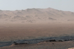 A vantage point on "Vera Rubin Ridge" provided NASA's Curiosity Mars rover this detailed look back over the area where it began its mission inside Gale Crater, plus more-distant features of the crater.This view toward the north-northeast combines eight images taken by the right-eye, telephoto-lens camera of Curiosity's Mast Camera (Mastcam). It shows more detail of a fraction of the area pictured in a more sweeping panorama (PIA22210) acquired from the same rover location using Mastcam's left-eye, wider-angle-lens camera. The scene has been white-balanced so the colors of the rock materials resemble how they would appear under daytime lighting conditions on Earth.The component images were taken on Oct. 25, 2017, during the 1,856th Martian day, or sol, of the rover's work on Mars. At that point, Curiosity had gained 1,073 feet (327 meters) in elevation and driven 10.95 miles (17.63 kilometers) from its landing site.Mount Sharp stands about 3 miles (5 kilometers) high in the middle of Gale Crater, which spans 96 miles (154 kilometers) in diameter. Vera Rubin Ridge is on the northwestern flank of lower Mount Sharp. The right foreground of this panorama shows a portion of Vera Rubin Ridge. In the distance is the northern wall of Gale Crater, with the rim crest forming the horizon roughly 25 miles (40 kilometers) from the rover's location. (NASA/JPL-Caltech/MSSS)