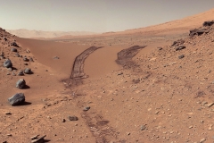 This look back at a dune that NASA's Curiosity Mars rover drove across was taken by the rover's Mast Camera (Mastcam) during the 538th Martian day, or sol, of Curiosity's work on Mars (Feb. 9, 2014). The rover had driven over the dune three days earlier. For scale, the distance between the parallel wheel tracks is about 9 feet (2.7 meters). The dune is about 3 feet (1 meter) tall in the middle of its span across an opening called "Dingo Gap." This view is looking eastward. (NASA/JPL-Caltech/MSSS)