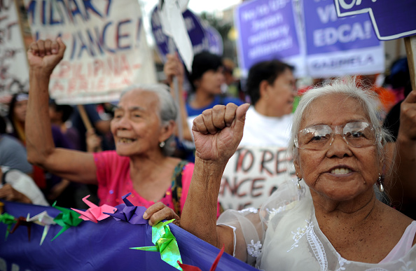 Filipina "comfort women", sex slaves for the Japanese Imperial army during World War II, join in a protest near the Malacanang Palace in Manila where visiting Japanese Emperor Akihito is meeting the Philippine president on January 27, 2016. The few remaining comfort women joined the protest calling to "right the historical wrong" as the Japanese emperor and empress are on a five-day visit to the Philippines. Credit: Noel Celis/AFP/Getty Images.